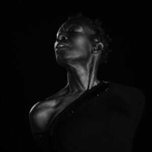 Alison Limerick in a dramatic black-and-white portrait, head tilted back with eyes closed.
